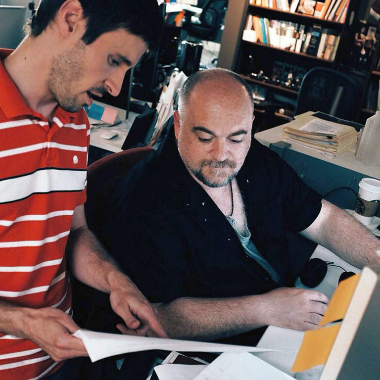 Two IU Brand Studio members review copy for a project