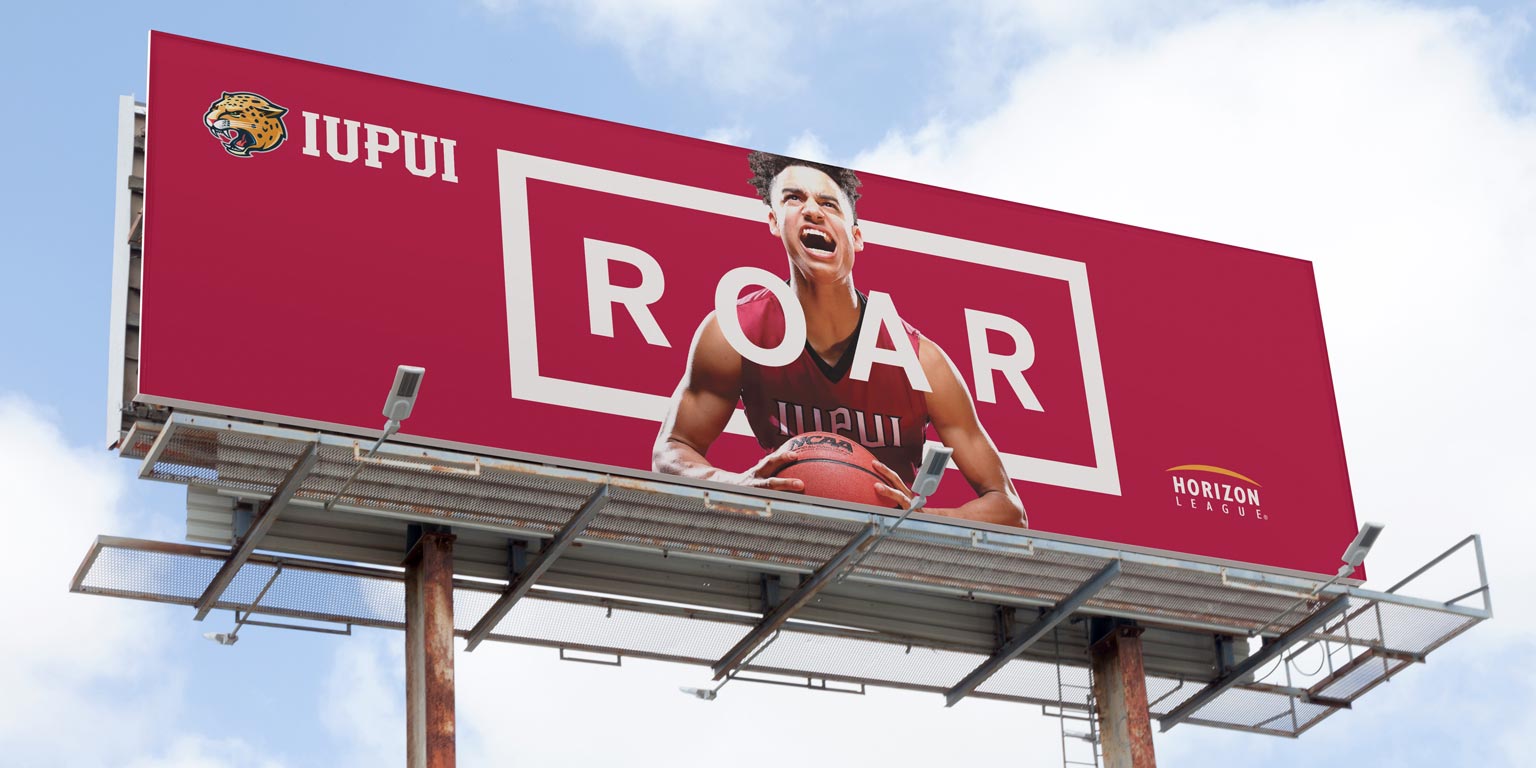 A billboard for the Roar campaign features an IUPUI male basketball player and the Horizon League logo